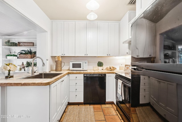 kitchen featuring tile countertops, black appliances, sink, white cabinets, and kitchen peninsula