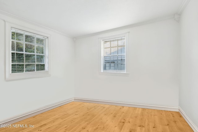 spare room with crown molding and wood-type flooring