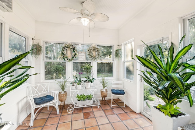 sunroom / solarium with ceiling fan and an AC wall unit