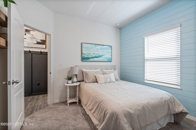 bedroom featuring carpet floors and wood walls