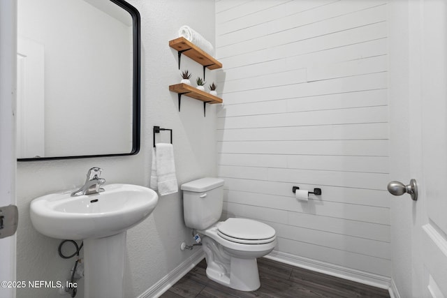 bathroom with wood-type flooring and toilet