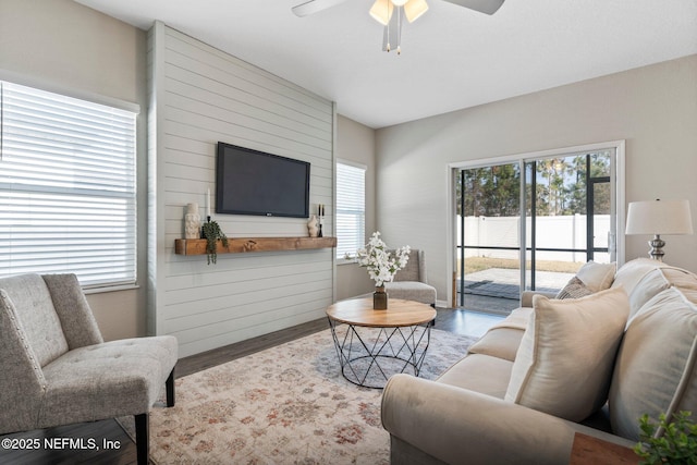 living room with hardwood / wood-style floors and ceiling fan