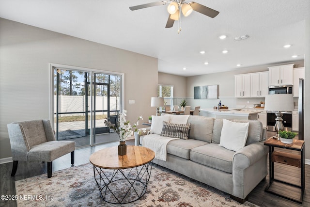 living room with ceiling fan and light hardwood / wood-style floors