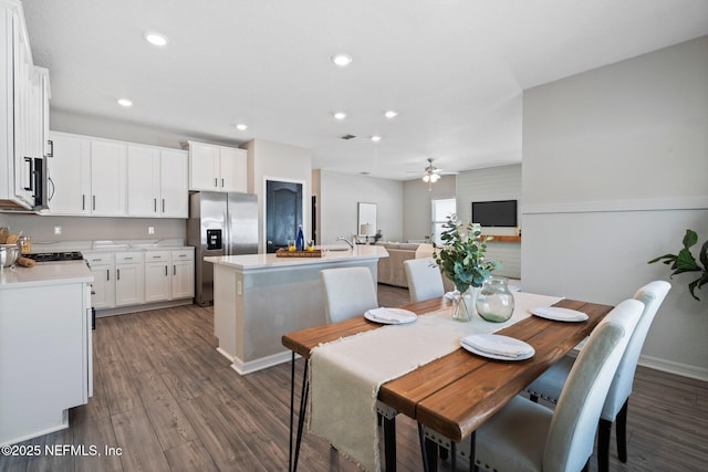 dining area featuring ceiling fan and dark hardwood / wood-style flooring