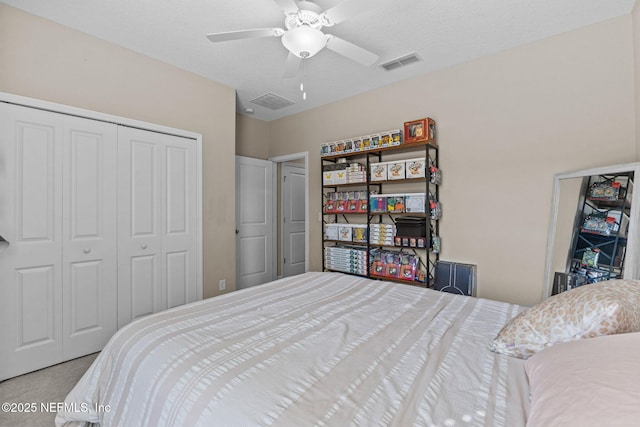 bedroom featuring a textured ceiling, a closet, ceiling fan, and carpet