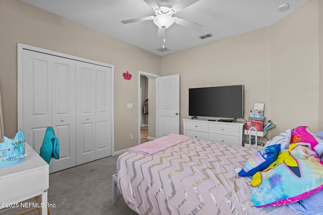 carpeted bedroom featuring ceiling fan and a closet