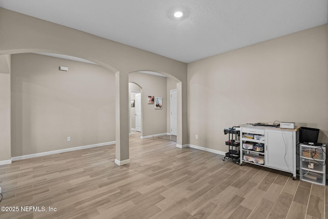 interior space with a textured ceiling and light wood-type flooring