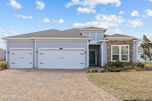 view of front of house featuring a garage and a front lawn