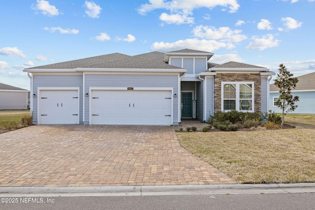 view of front of house with a garage and a front lawn