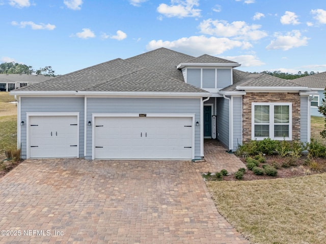 view of front of house featuring a garage and a front lawn