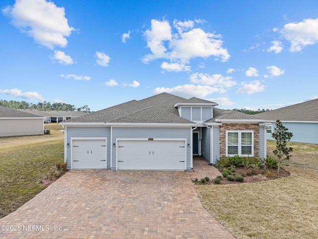 view of front of home with a garage and a front yard