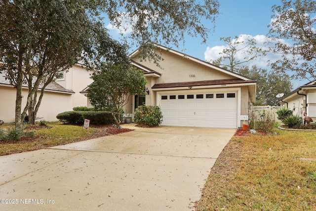 view of front of property featuring a garage, concrete driveway, fence, and stucco siding