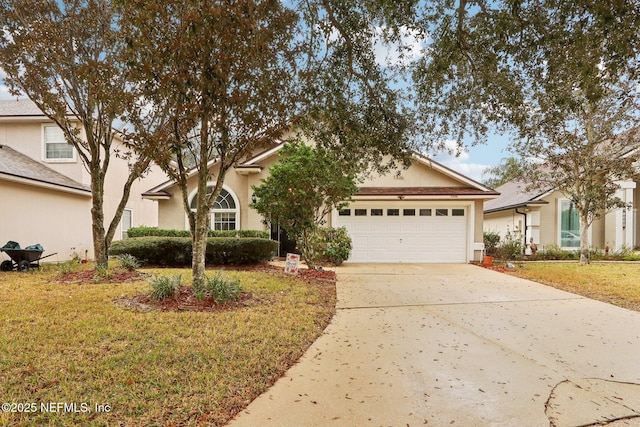 1336 River City St, Saint Augustine, FL 32092 - view of front of property with a front lawn, concrete driveway, an attached garage, and stucco siding