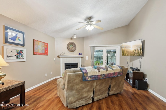 1336 River City St, Saint Augustine, FL 32092 - living area with a textured ceiling, dark wood-type flooring, a tile fireplace, and baseboards