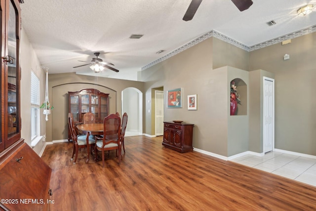 1336 River City St, Saint Augustine, FL 32092 - dining room featuring arched walkways, a textured ceiling, wood finished floors, visible vents, and a ceiling fan