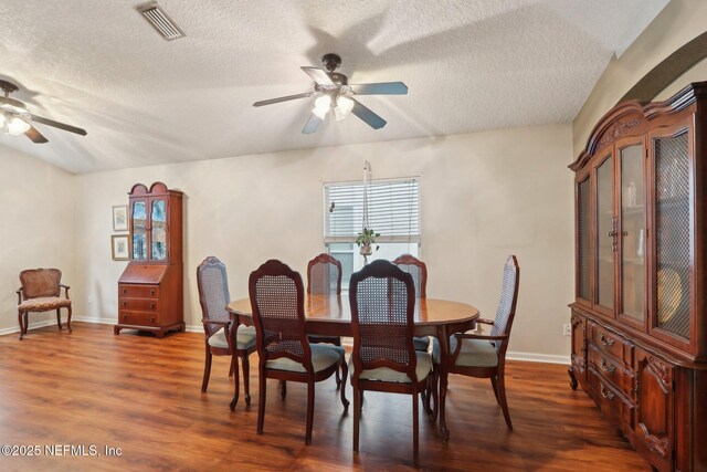 1336 River City St, Saint Augustine, FL 32092 - dining area with a textured ceiling, dark wood-style flooring, visible vents, baseboards, and a ceiling fan