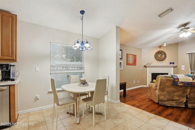 1336 River City St, Saint Augustine, FL 32092 - dining room with a tile fireplace, visible vents, a textured ceiling, and ceiling fan with notable chandelier