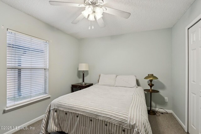 1336 River City St, Saint Augustine, FL 32092 - carpeted bedroom with ceiling fan, a textured ceiling, and baseboards
