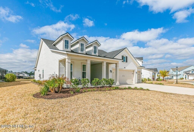 view of front of property with a porch, a garage, and a front yard