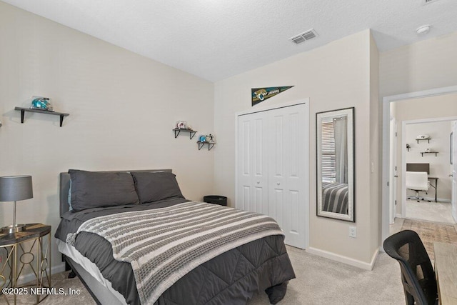 carpeted bedroom with a closet