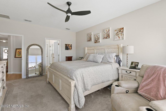 carpeted bedroom featuring connected bathroom and ceiling fan