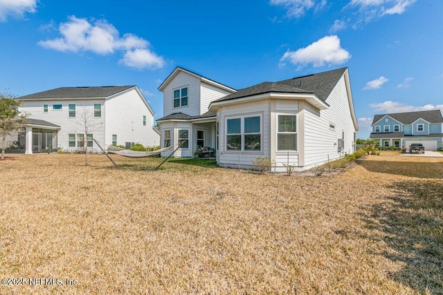back of house with a lawn