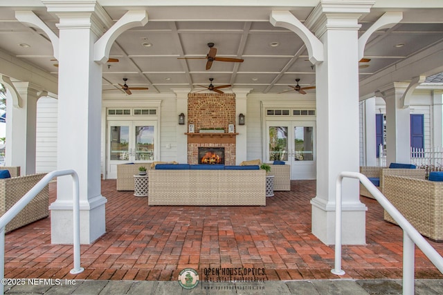 view of patio / terrace featuring french doors and an outdoor living space with a fireplace