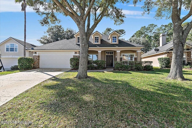 view of front of property featuring a garage, a front yard, and covered porch