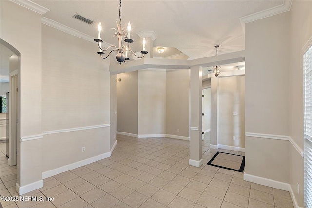 spare room with a notable chandelier, crown molding, and light tile patterned floors