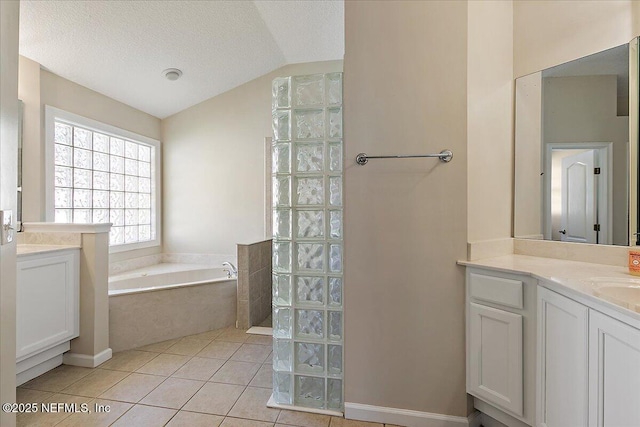 bathroom featuring vaulted ceiling, vanity, separate shower and tub, tile patterned floors, and a textured ceiling