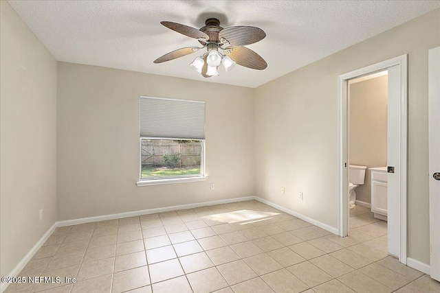 tiled spare room with ceiling fan and a textured ceiling