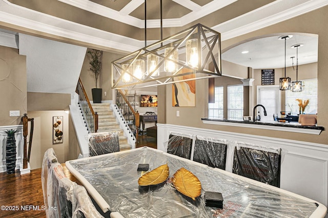 dining room featuring crown molding, wood-type flooring, and a chandelier