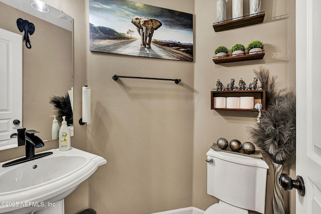 bathroom featuring sink and toilet