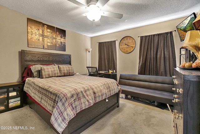 bedroom featuring ceiling fan, light carpet, and a textured ceiling