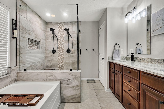 bathroom with vanity, tile patterned flooring, independent shower and bath, and a textured ceiling