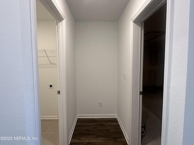 corridor with baseboards and dark wood-style flooring