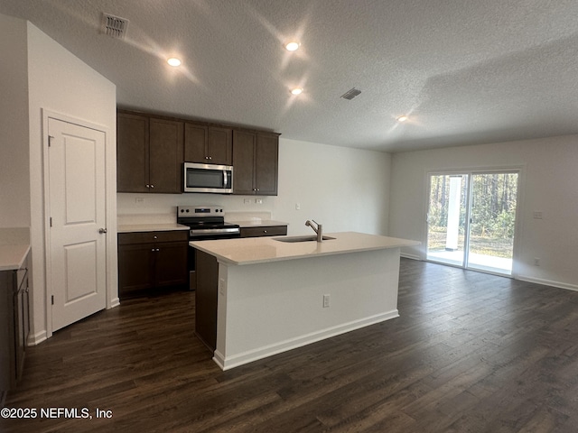 kitchen with dark wood-type flooring, light countertops, visible vents, and stainless steel appliances