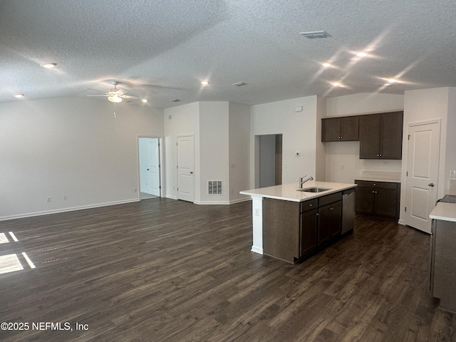 kitchen featuring visible vents, lofted ceiling, dark wood-style flooring, a sink, and open floor plan