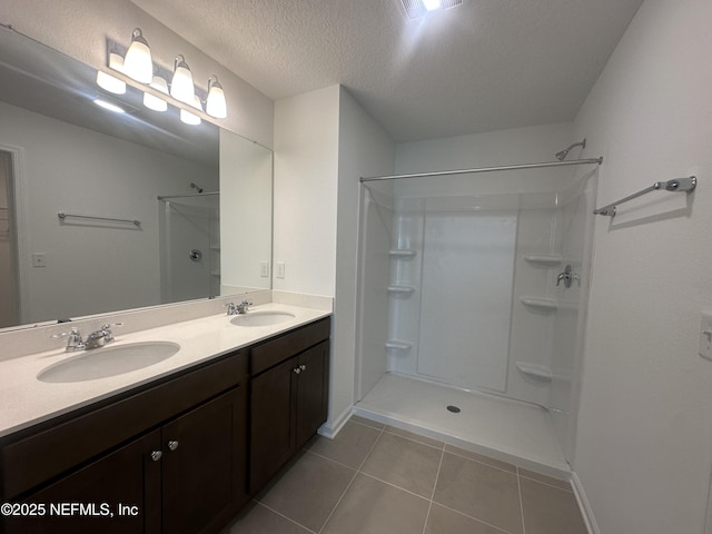 full bath featuring tile patterned flooring, a shower, and a sink