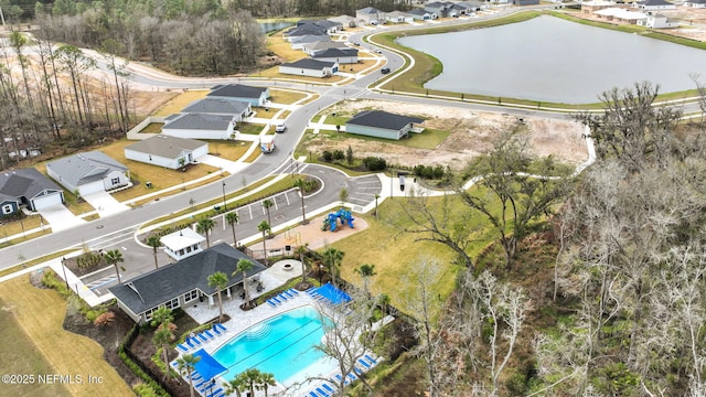 drone / aerial view with a residential view and a water view