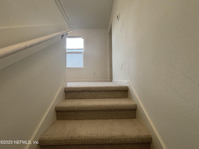 stairway with vaulted ceiling