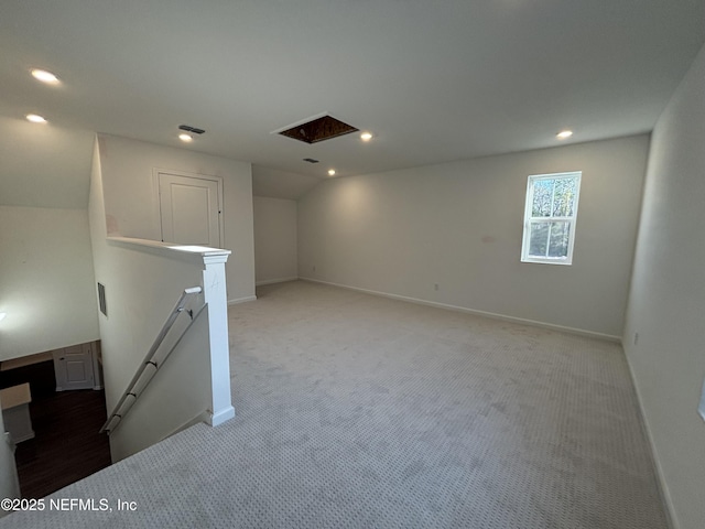 basement with baseboards, visible vents, light colored carpet, and recessed lighting