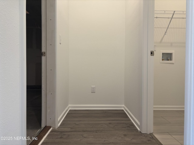 corridor featuring dark wood-style floors and baseboards