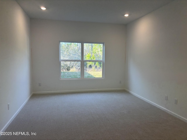 carpeted empty room with recessed lighting and baseboards