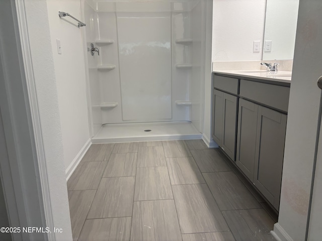 full bath featuring a walk in shower and vanity