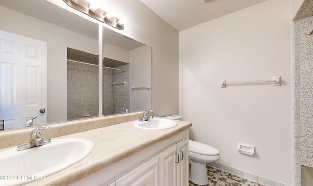 bathroom with walk in shower, vanity, and toilet