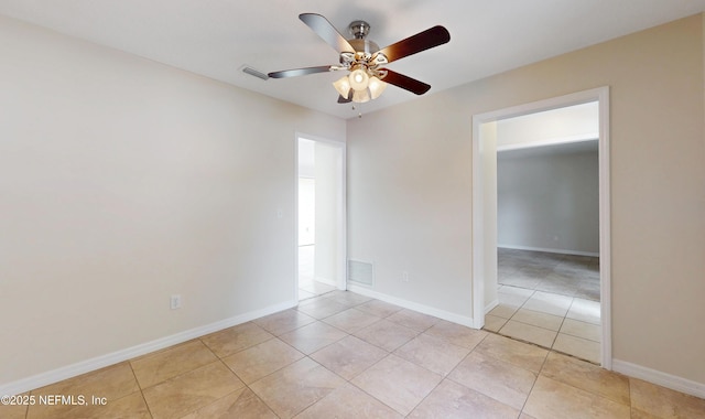 spare room featuring light tile patterned floors and ceiling fan