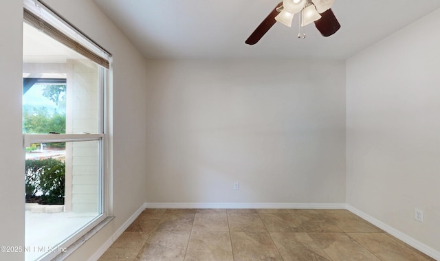 unfurnished room with ceiling fan and light tile patterned floors