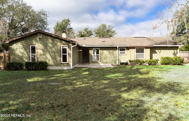 rear view of property featuring a yard and a patio