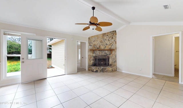 unfurnished living room featuring ceiling fan, a stone fireplace, lofted ceiling with beams, and light tile patterned floors